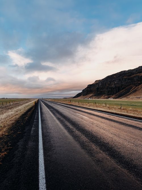 Free Long empty road cutting through the scenic Icelandic countryside. Stock Photo