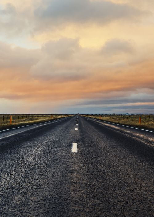 Free A captivating view of a rural asphalt road leading into the sunset in Iceland's countryside. Stock Photo
