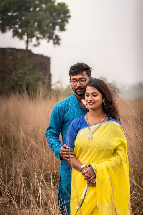 Free Beautiful couple in traditional Indian clothing posing in a rural setting in Orgram, India. Stock Photo