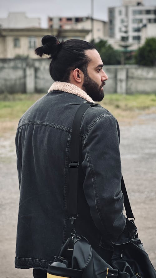 Man Wearing Denim Jacket on a Street 