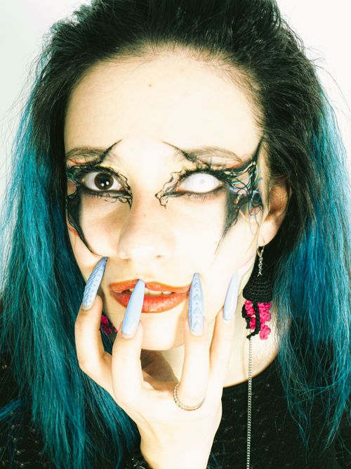 Free Close-up portrait of a woman with gothic makeup and long nails, perfect for Halloween. Stock Photo