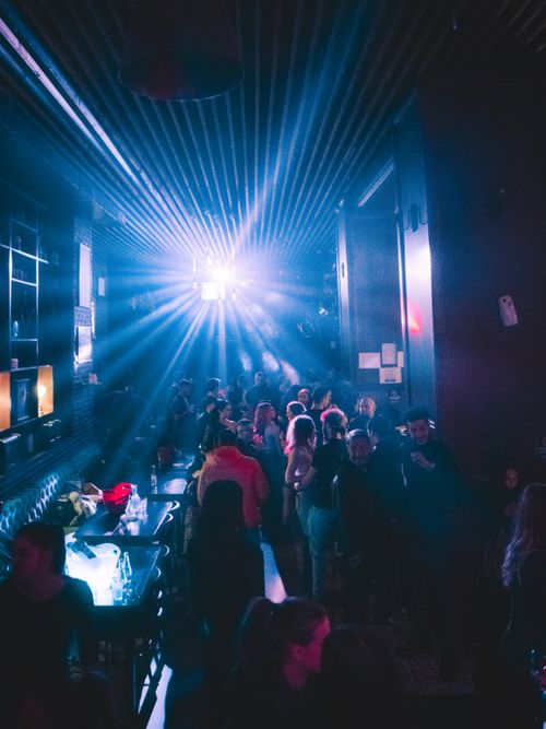 Free Energetic nightclub ambiance with vibrant lighting and people enjoying the night out. Stock Photo
