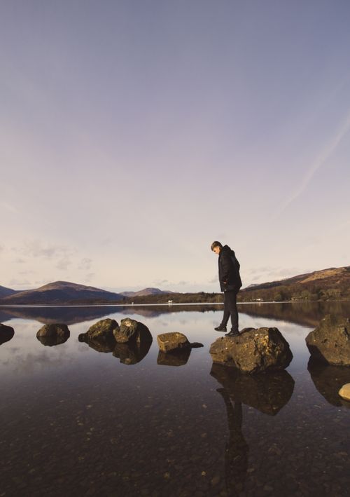 Figure standing in still water by Cameron Rainey on Pexels
