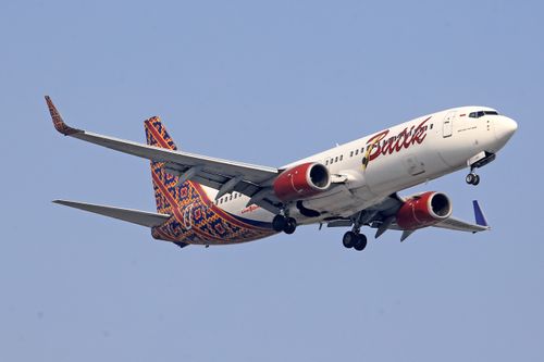 Free A Batik Air airplane soaring through a clear blue sky, showcasing transportation and travel. Stock Photo