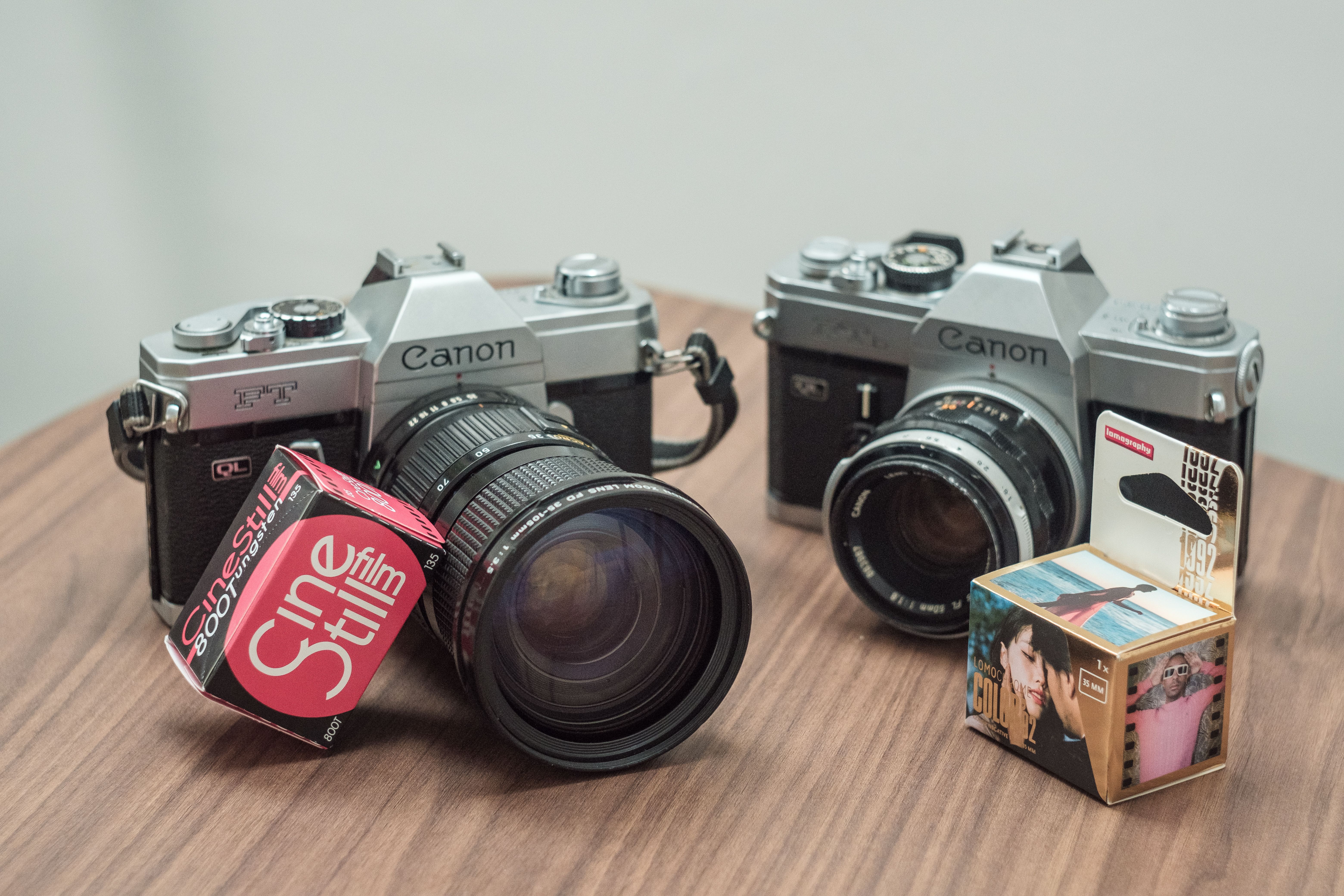 Two chrome Canon SLRs