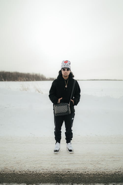 Man with Bag Standing in Snow