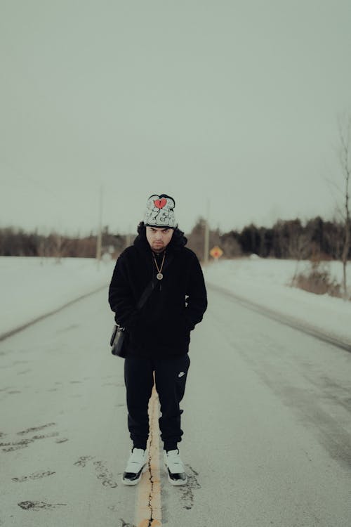 Man Standing on Road in Winter