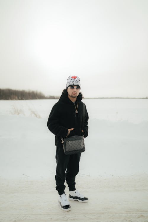 Man in Hat and Sunglasses on Road in Winter