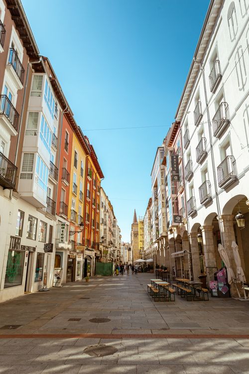 Free Explore a picturesque alley in Burgos, Spain, with vibrant buildings under a clear sky. Stock Photo