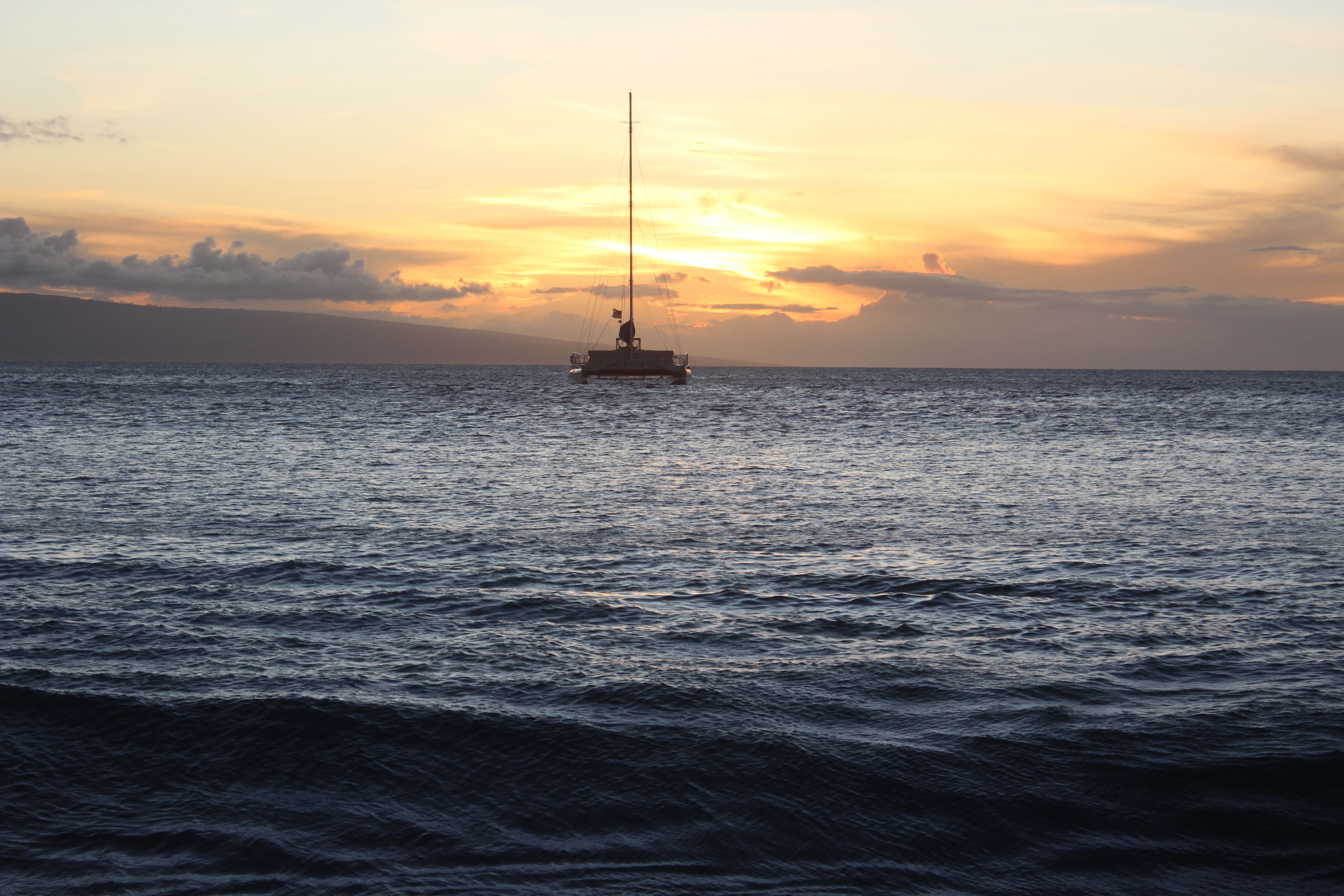 Incredible Waikiki Sunset Cocktail Cruise aboard the Majestic by Atlantis Review: Your Ultimate Guide to Hawaii's Most Romantic Evening on the Water Review 2026 - A serene view of a sailboat against a stunning Hawaiian sunset over calm seas.