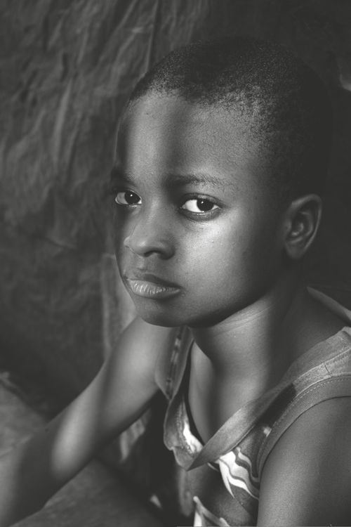 Free Thoughtful young boy in a black and white portrait with a dramatic lighting effect. Stock Photo