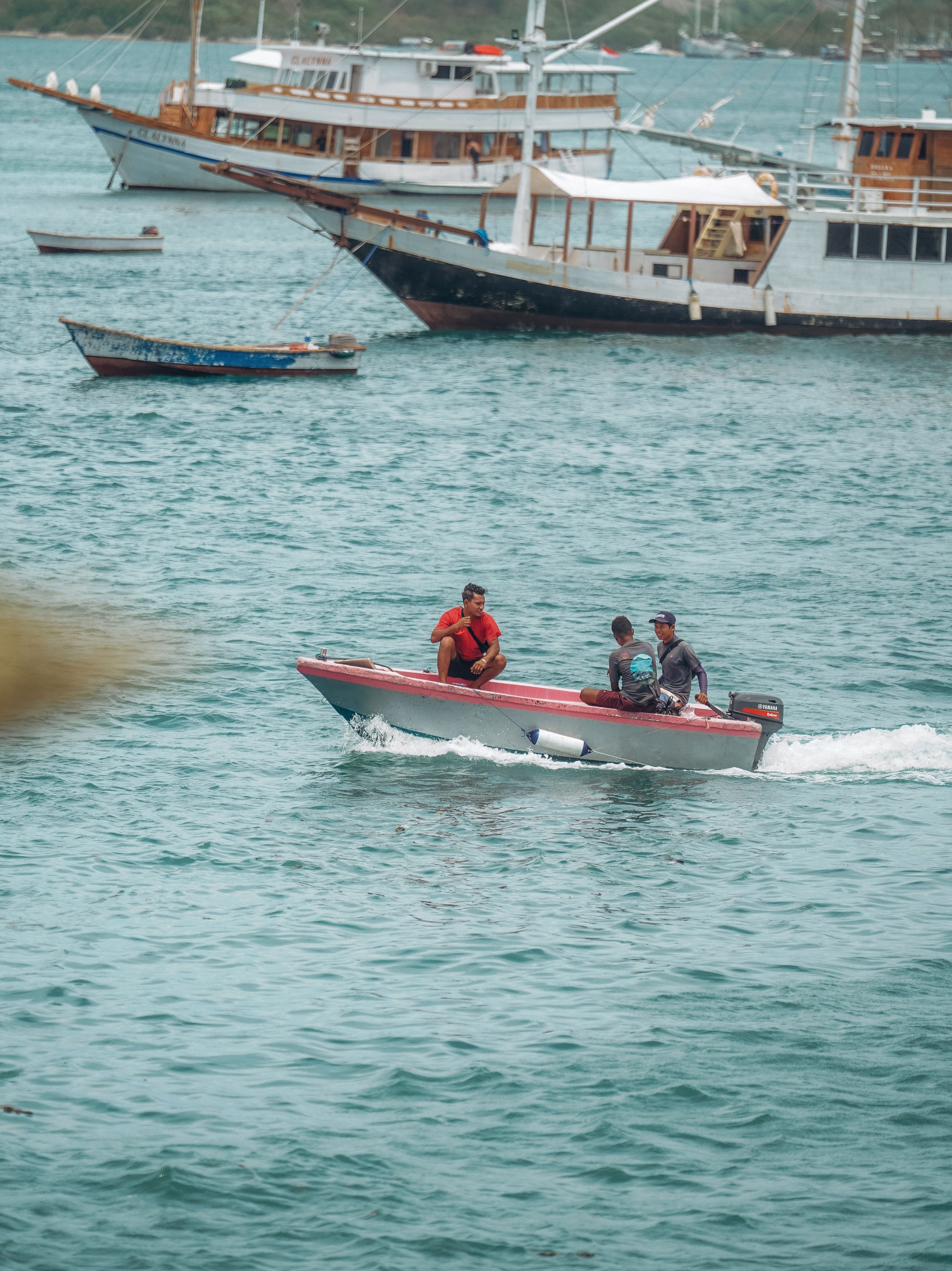 Men on Motorboat on Sea Coast · Free Stock Photo