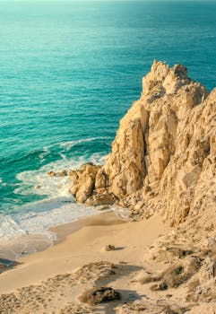 Discover the stunning rocky coastline of Cabo San Lucas with turquoise waters and golden sands.