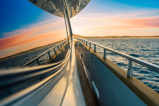 Experience the serene beauty of sunset on a yacht with a panoramic ocean view.
