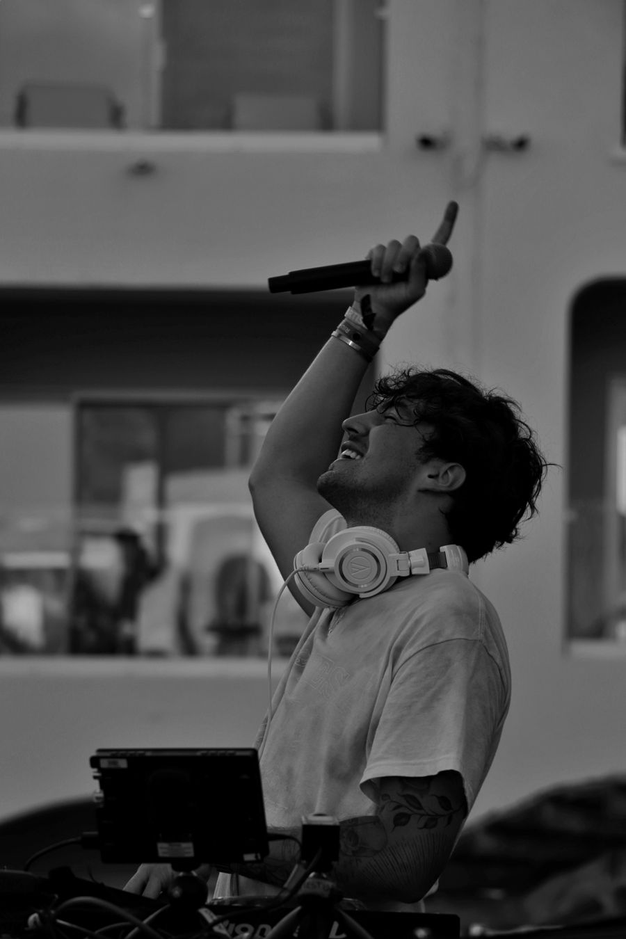 Professional DJ and MC performing with a microphone for guests