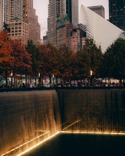 Free Autumn view of the 9/11 Memorial with city skyscrapers in New York. Stock Photo