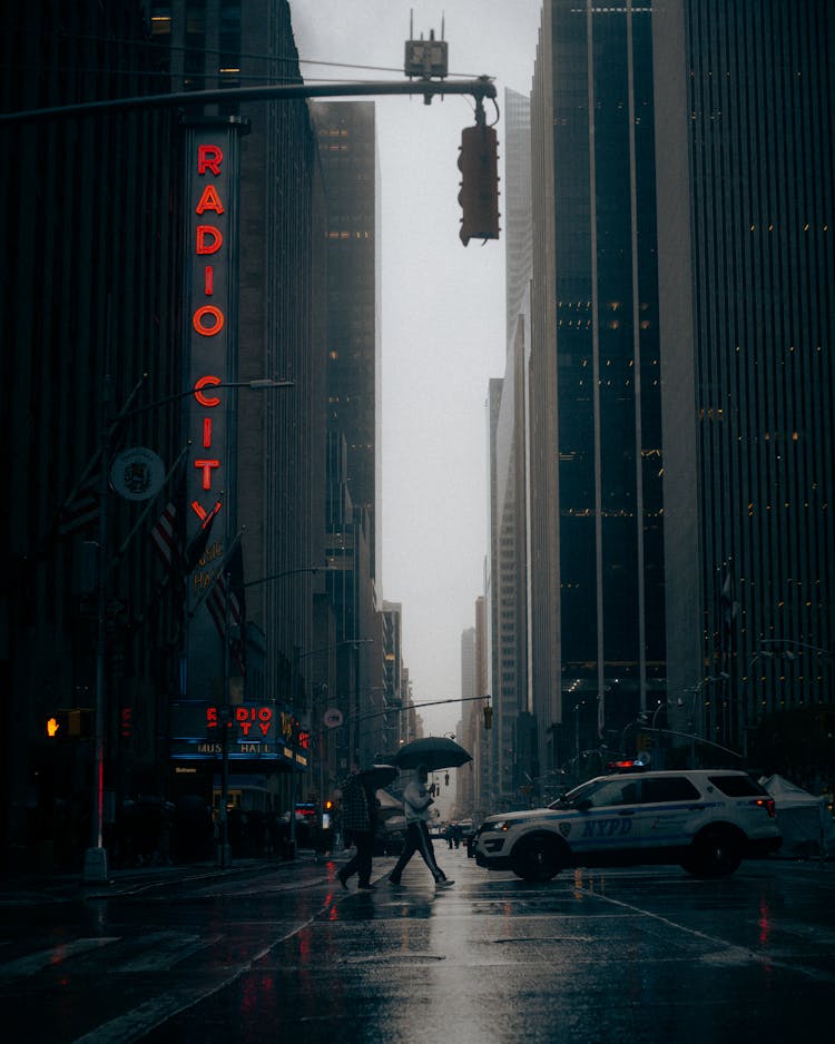 People Crossing Street In Rain In New York