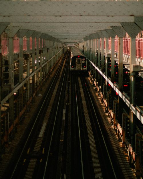Free A subway train travels along tracks on a bridge in an urban setting, showcasing public transportation. Stock Photo