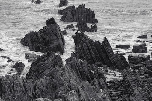 Barren Rocks on Sea Shore in Black and White