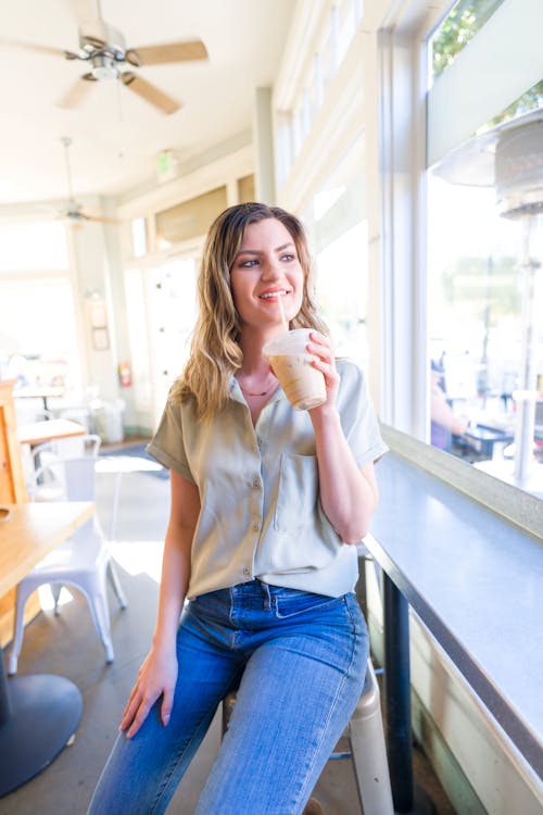 Smiling Blonde Woman Sitting in White Shirt