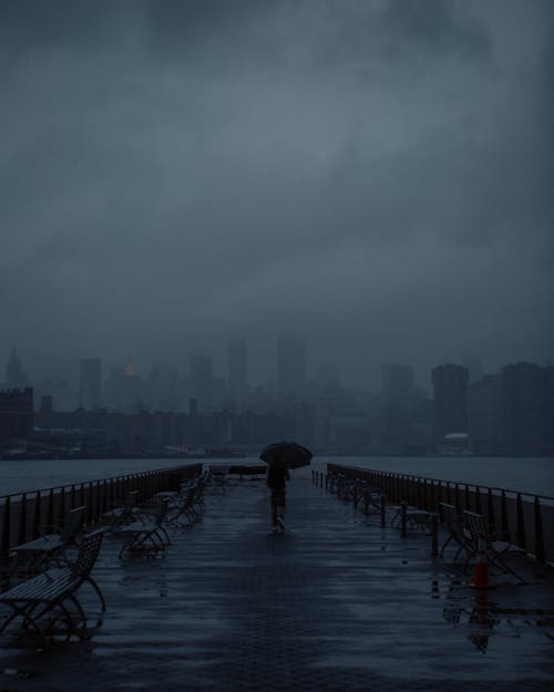 Person Walking on Pier under Fog and Cloud in New York