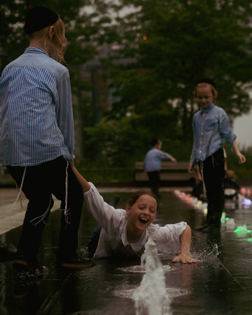 Girl and Boys Playing in Water