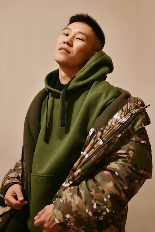 Portrait of Man in Jacket and Green Hoodie