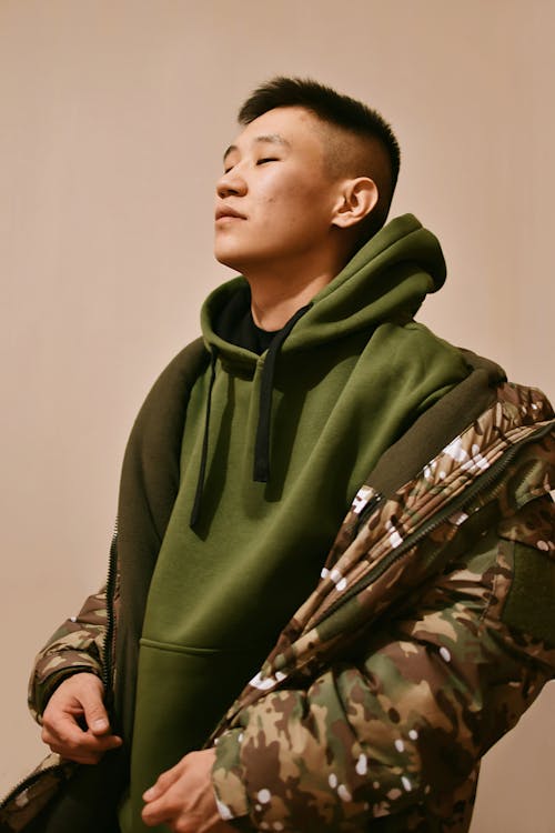 Portrait of Man in Jacket and Green Hoodie