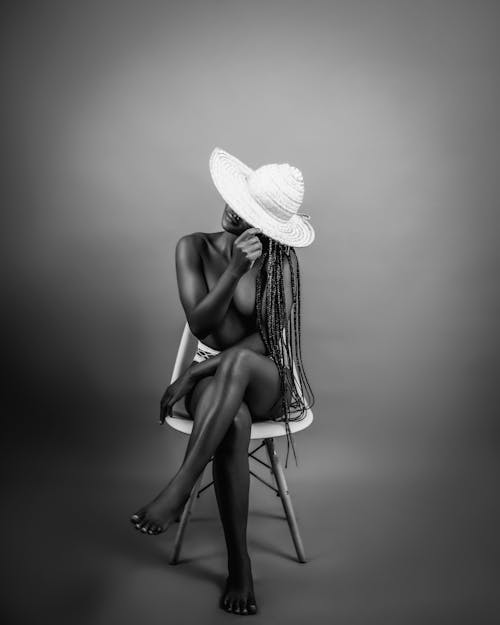 Topless Woman Sitting in Hat