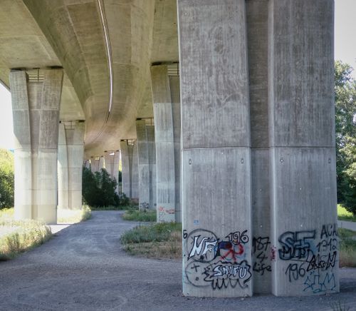 Free Concrete pillars of an elevated bridge in Pforzheim, featuring urban graffiti art. Stock Photo