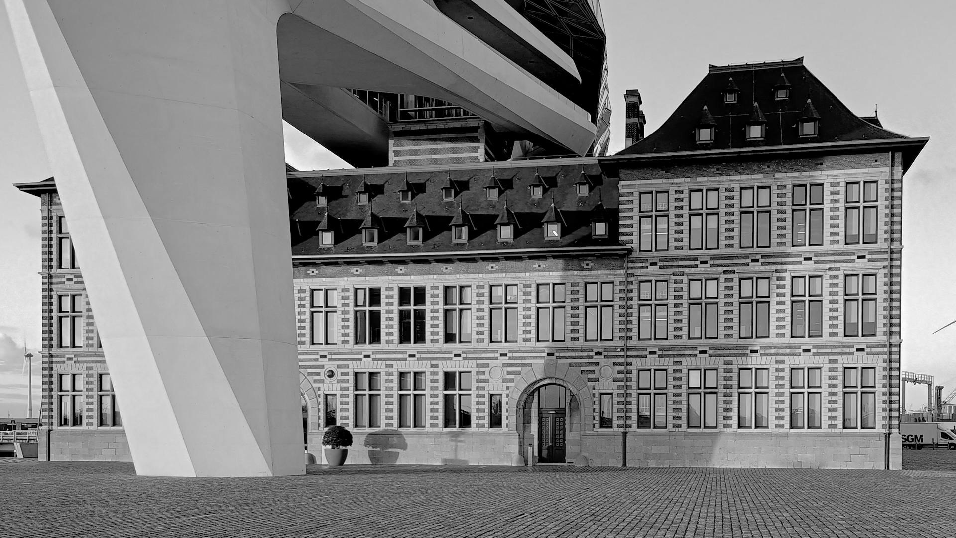 Black and white image of the striking Port House in Antwerp, Belgium with modern and classic architecture.