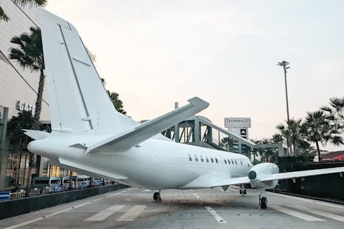 Airplane Model on Street at Airport in City