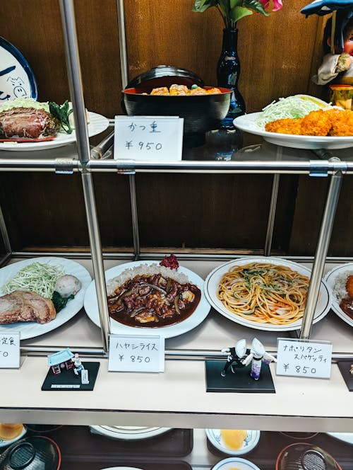 A display of food on a shelf with plates and bowls