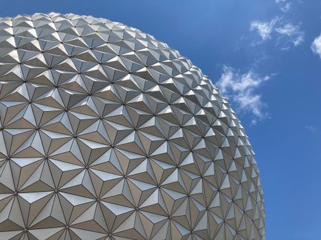 Close-up view of the iconic geodesic sphere at Epcot, Orlando, beautifully captured with a clear blue sky backdrop.