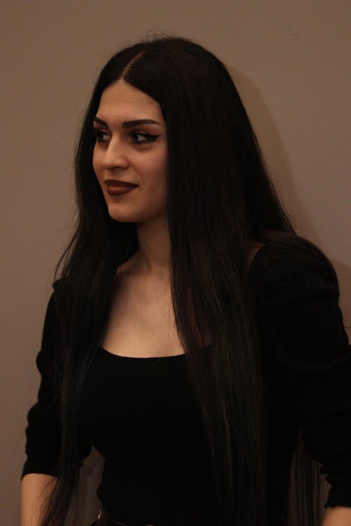 A woman with long black hair posing for a photo