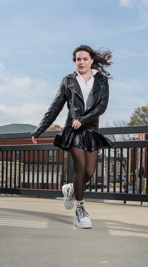 Woman in Skirt and Leather Jacket