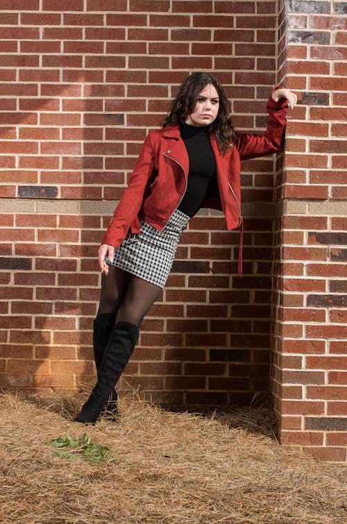 Model in a Red Jacket on a Black Blouse and a Checkered Mini Skirt 