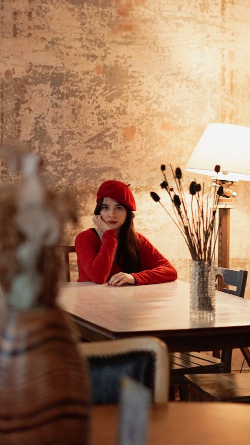 Woman in Red Beret Sitting at Cafe