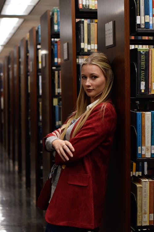Blonde Woman in Red Suit Jacket at Library