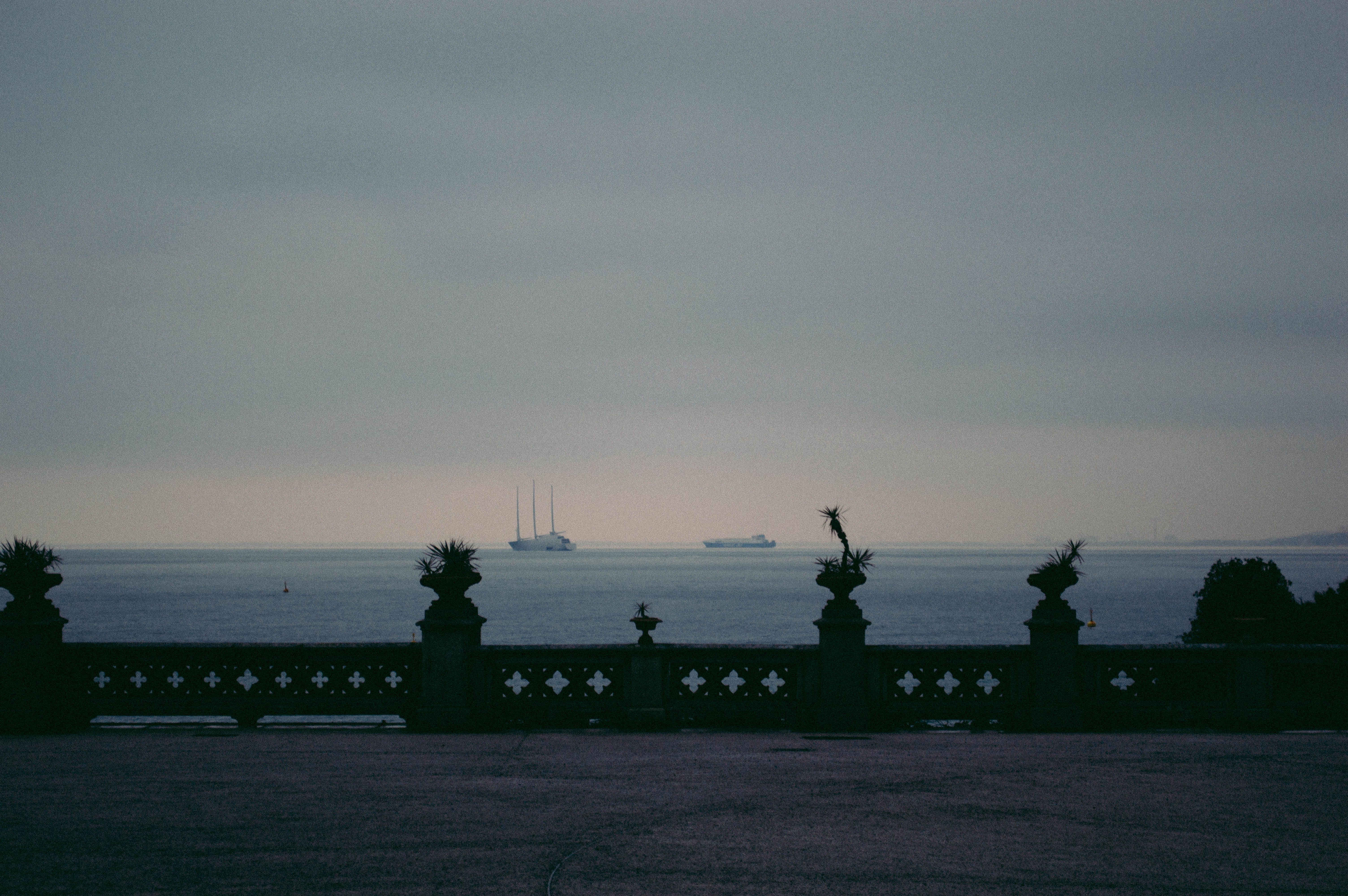Vessel view from a promenade in Trieste, Italy, with the Adriatic Sea stretching into the horizon, capturing a serene and tranquil atmosphere. — Trójmiasto