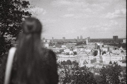 City behind Woman in Black and White