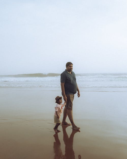 Father Walking with Daughter on Sea Shore