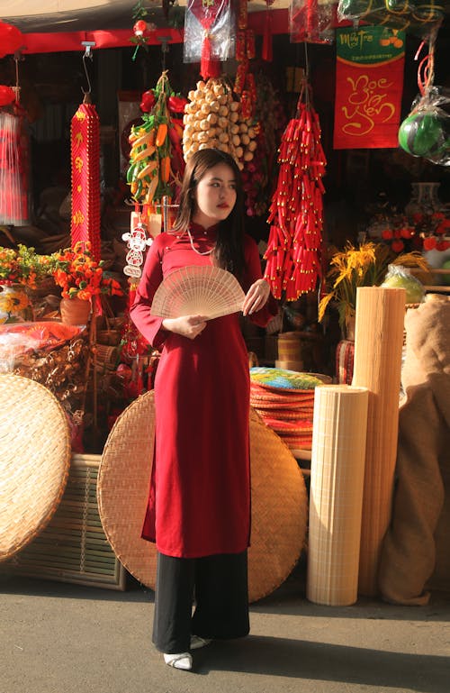 Woman with Fan and in Red, Traditional Clothing at Bazaar
