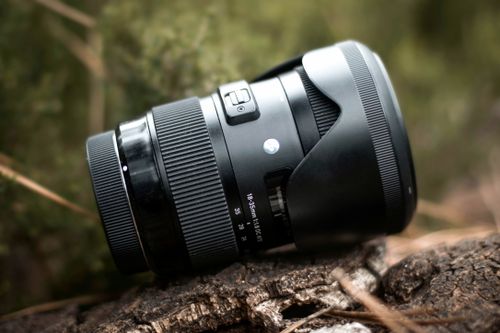 Free A macro shot of a camera lens placed outdoors, featuring selective focus and natural lighting. Stock Photo