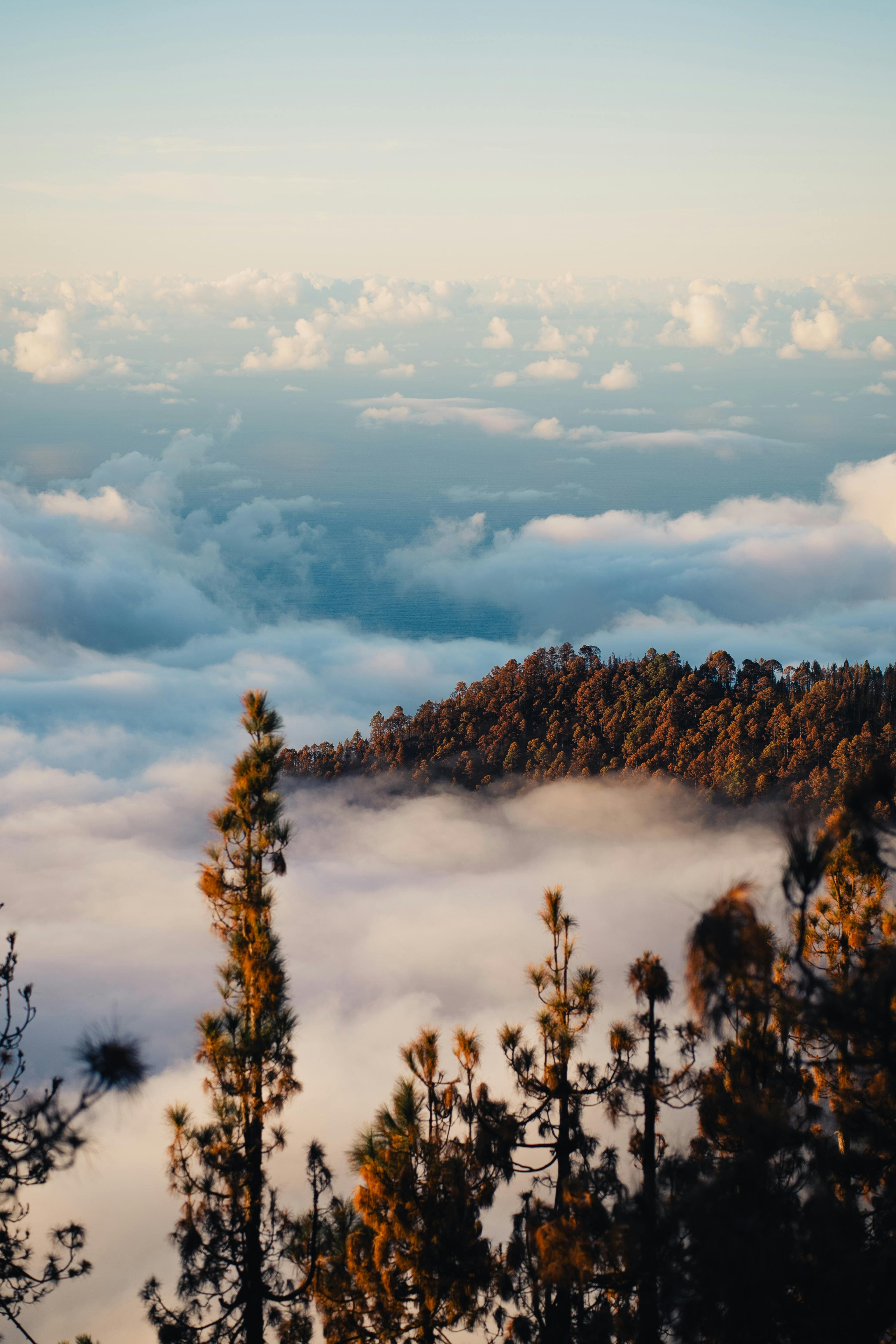 Breathtaking mountain view with clouds and sunlight creating a stunning natural scene.