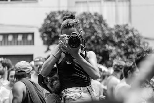 Free Grayscale Photography Of Man Carrying Woman While Taking Picture Stock Photo