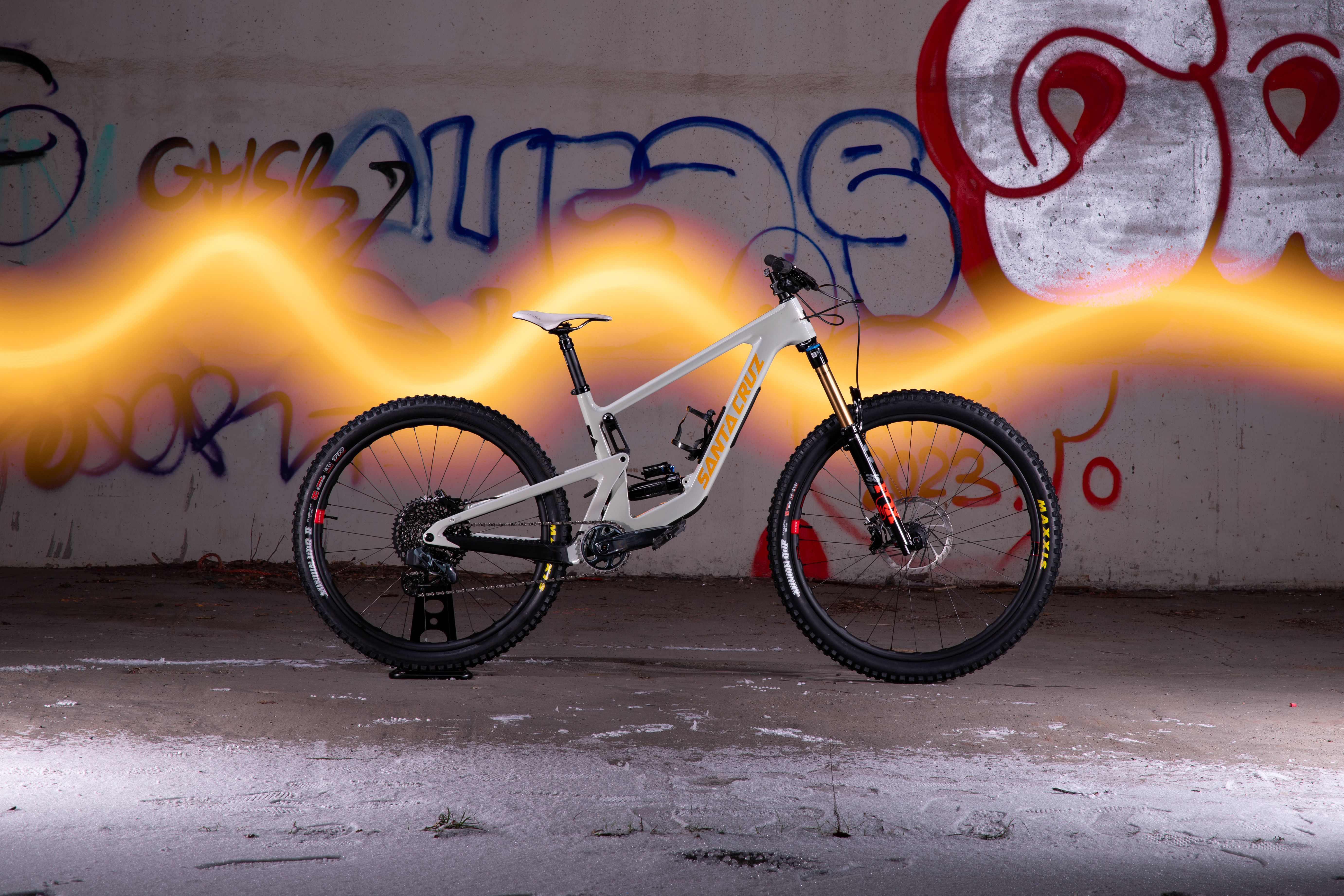 Dynamic image of a mountain bike in Prague with graffiti and light effects.