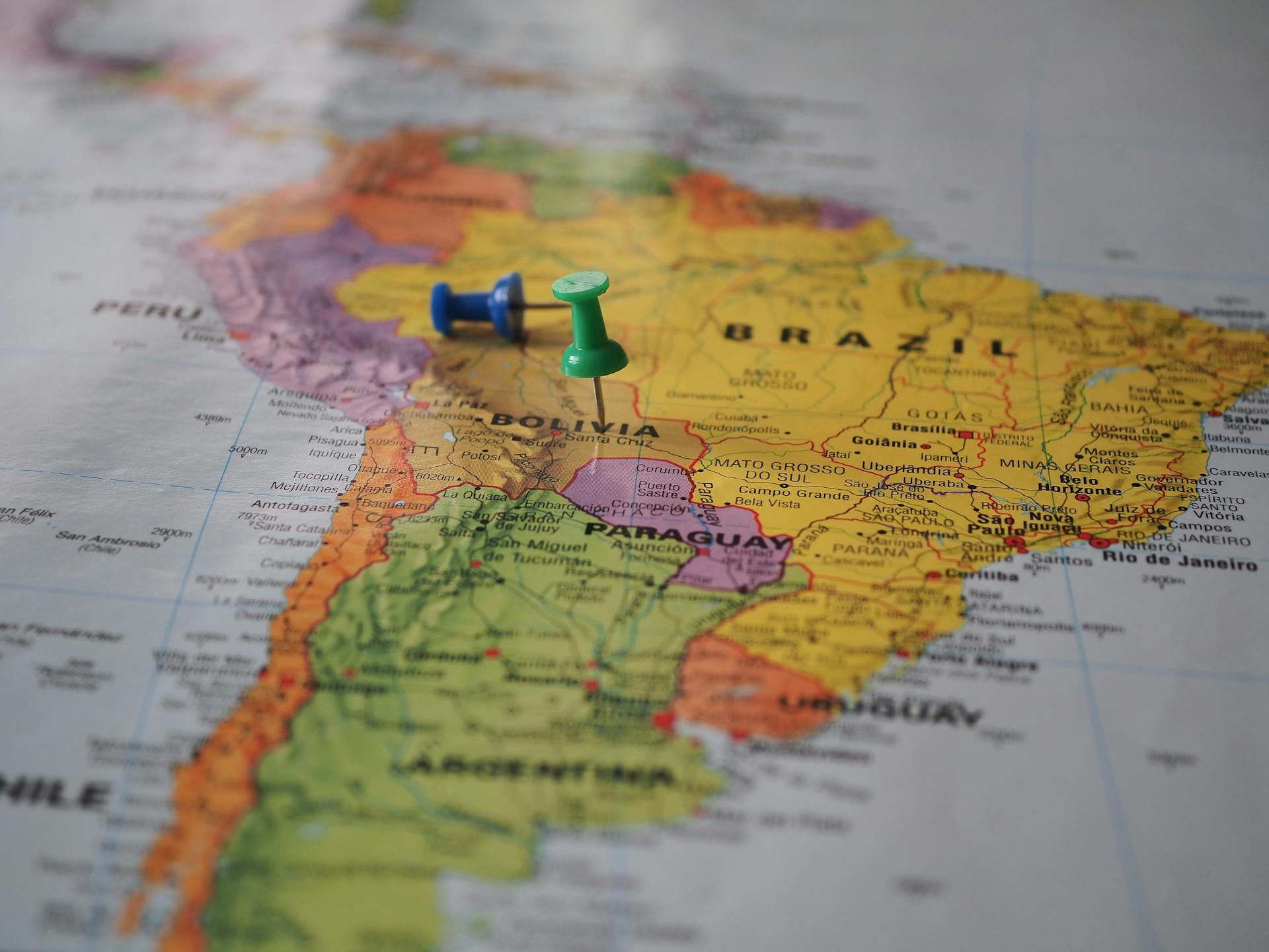 Close-up of a map of South America with pins marking locations in Brazil and Bolivia.