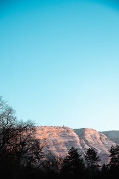 Capture of a tranquil mountain landscape at sunrise in Genève, showcasing serene nature.