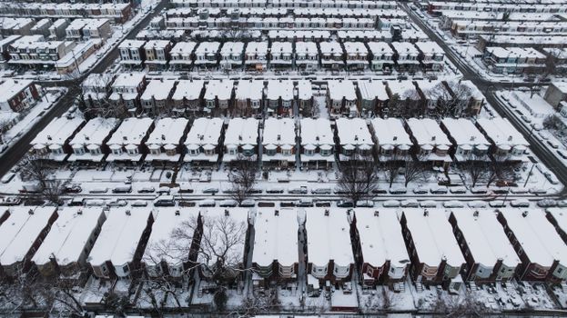 Aerial photograph of snow-covered row houses in Philadelphia, PA during winter.